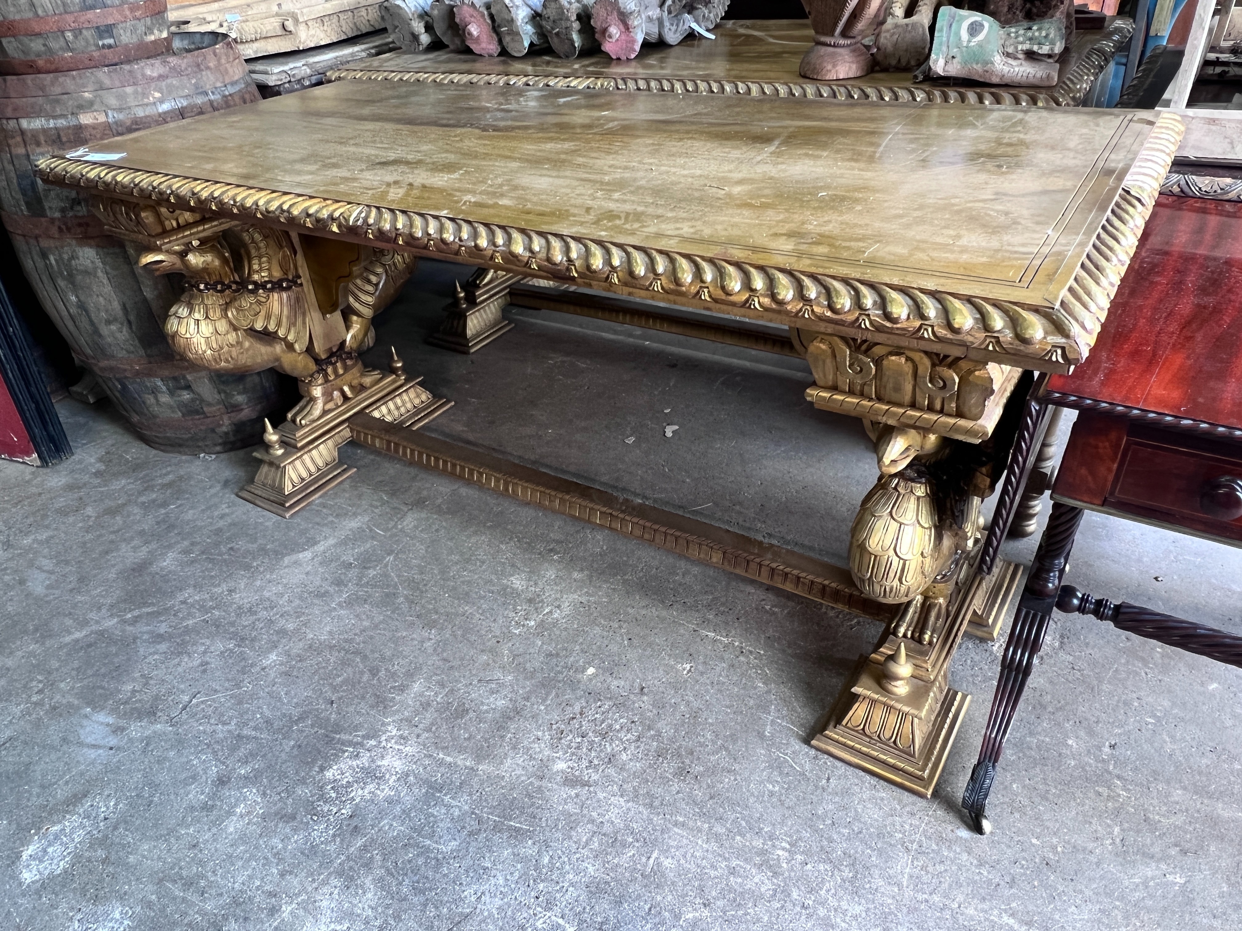 A pair of Renaissance style rectangular giltwood and composition centre tables, on chained eagle supports, width 184cm, depth 82cm, height 86cm